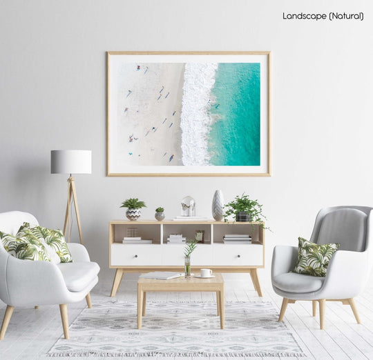 Aerial of green ocean at camps bay beach with people in cape town in a natural fine art frame