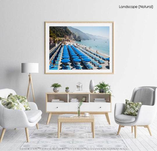 Rows of blue umbrellas along blue mediterranean sea in Cinque Terre in a natural fine art frame