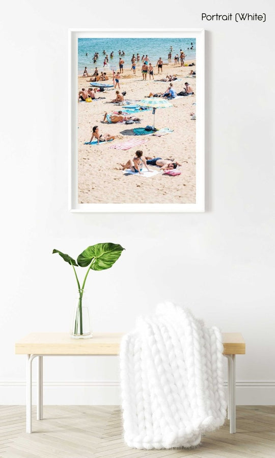 People tanning, swimmers and umbrellas at a beach in Cascais Portugal in a white fine art frame