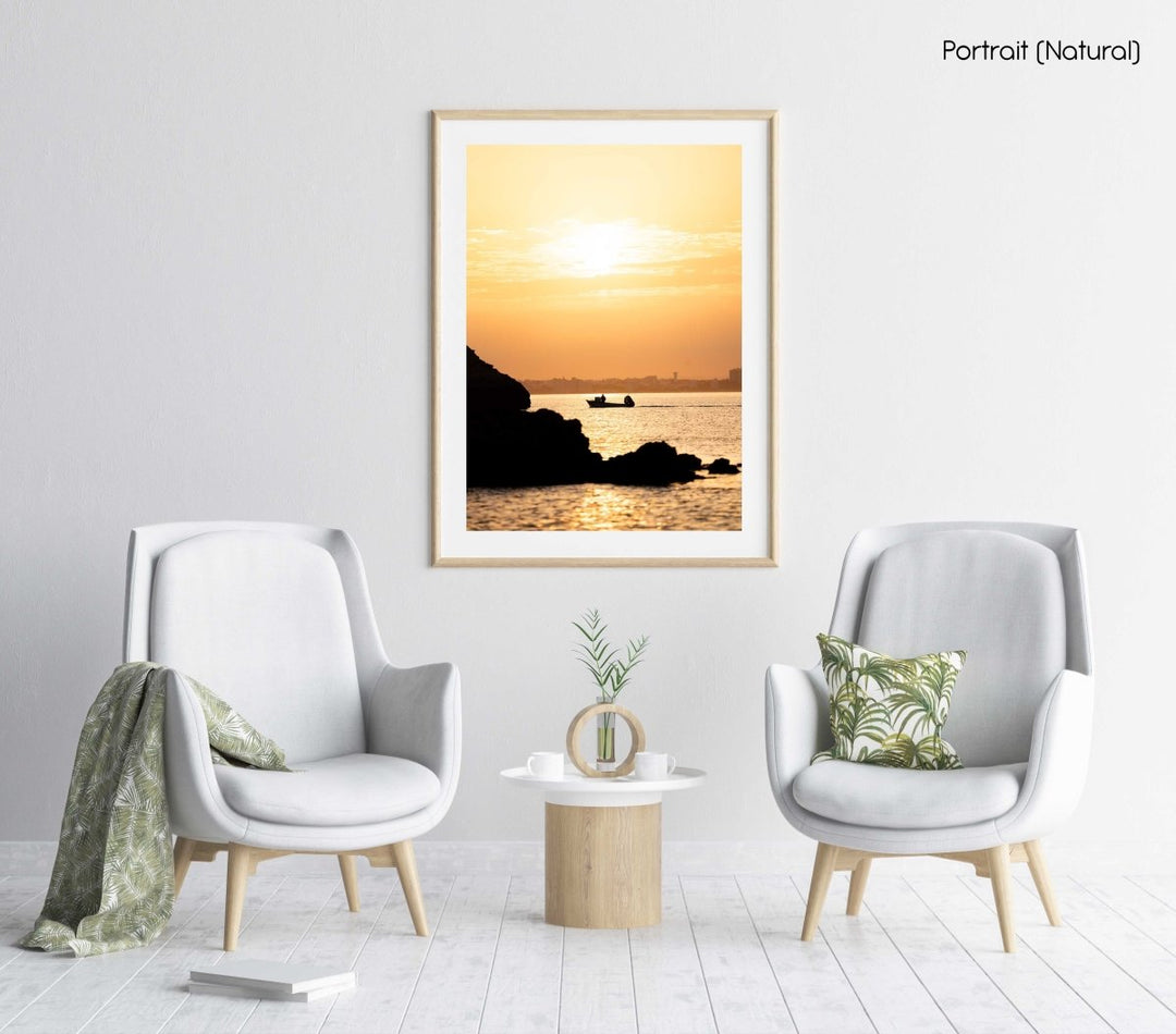 Orange sunrise with a boat cruising past Lagos coastline in a natural fine art frame