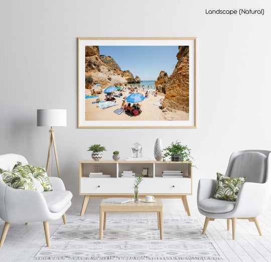 Blue umbrellas and people on Camilo beach Portugal in a natural fine art frame