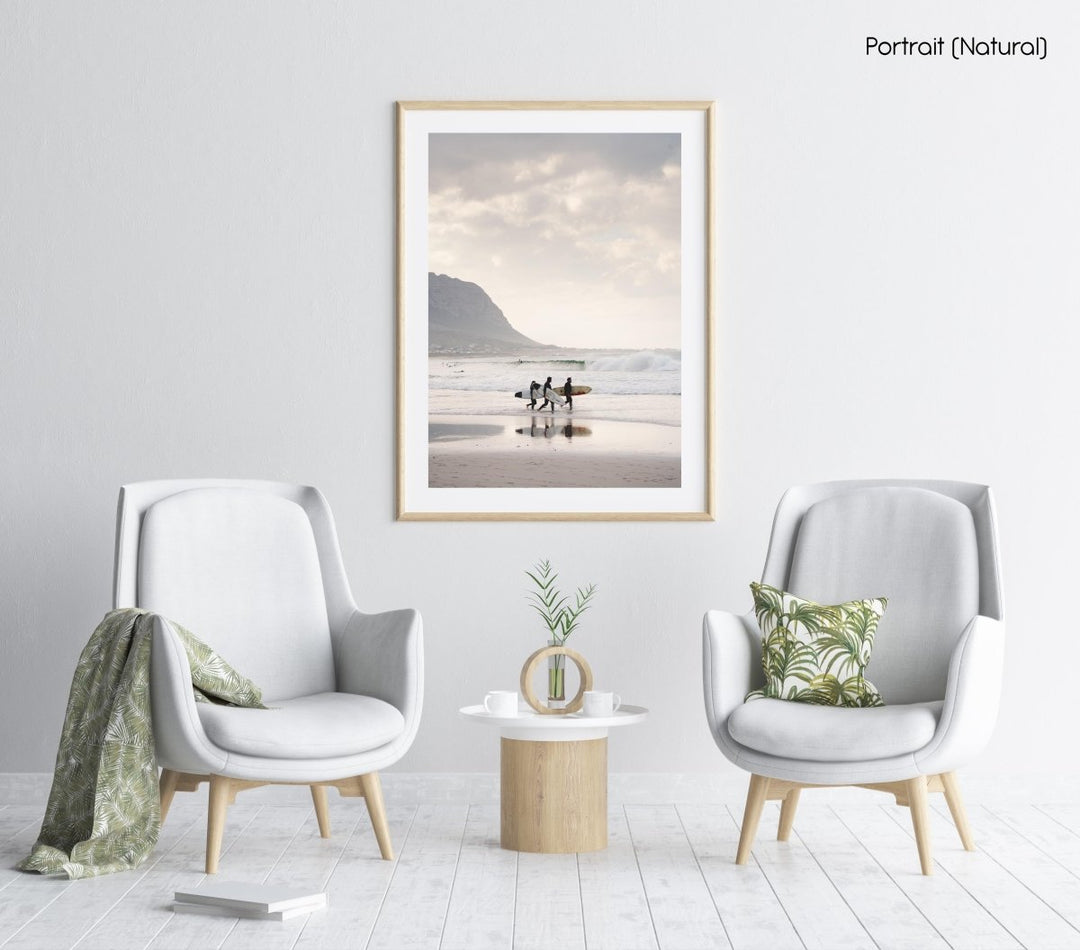 Three surfers walking at Betty's Bay Beach