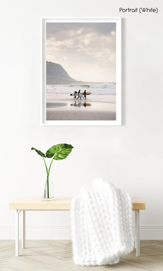 Three surfers walking at Betty's Bay Beach