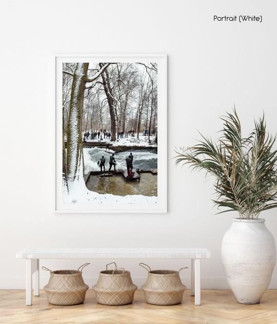 People surfing river wave in the city during snowfall in munich.