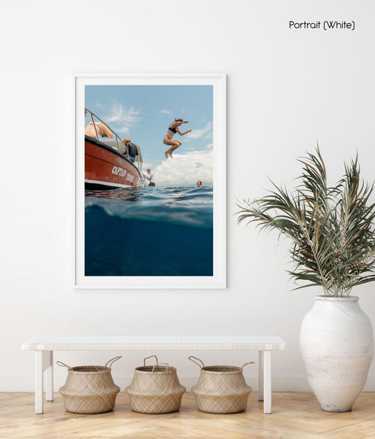 Girl jumping off boat in Bali, Indonesia on Nusa Lembongan island.