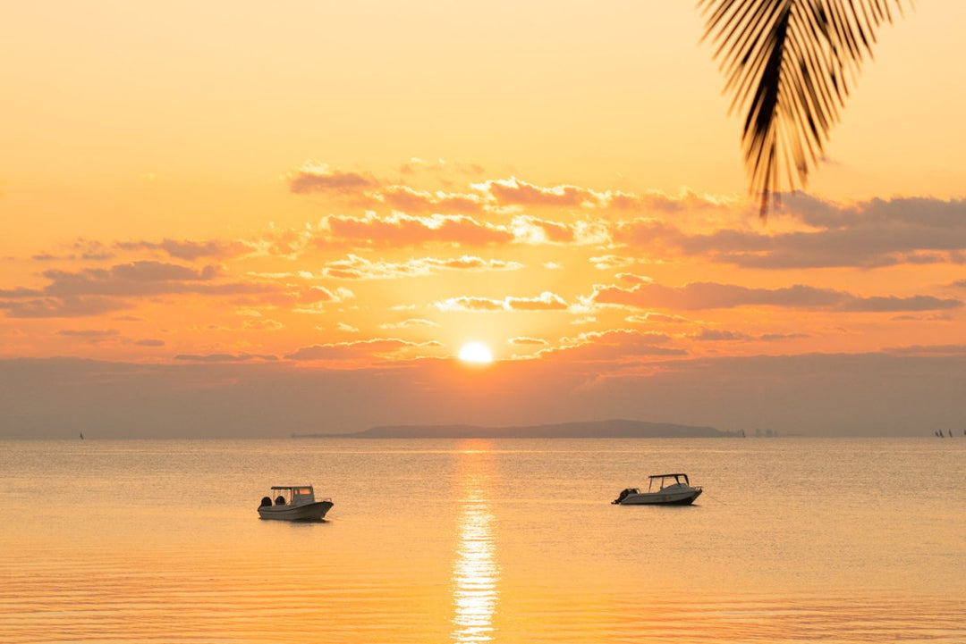 Orange sunrise over calm ocean water in Bazaruto Archipelago, Mozambique