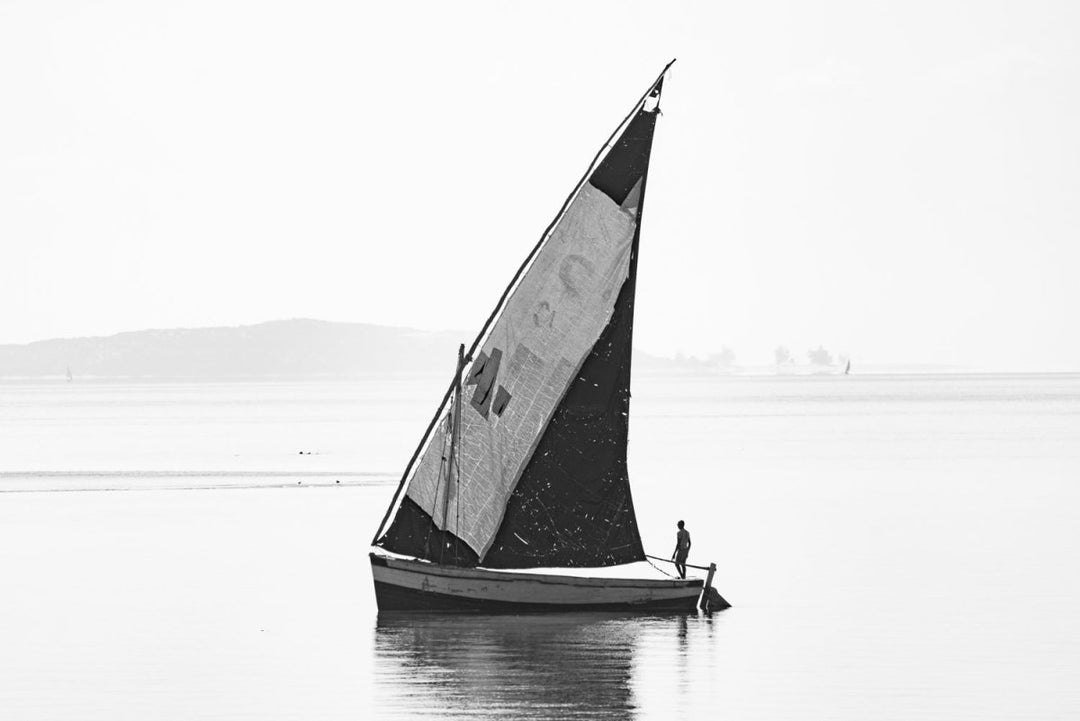 Black and white image of man on dhow boat in Bazaruto Archipelago, Mozambique