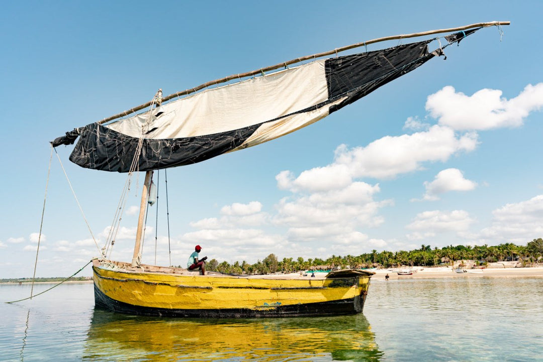 Local kid sitting in yellow dhow boat in Vilankulos, Bazaruto Archipelago, Mozambique