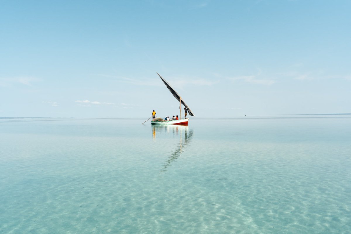 Dhow boat in shallow ocean water in Bazaruto Archipelago, Mozambique