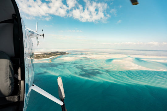 Helicopter image flying over the bright blue sea and islands in Bazaruto Archipelago, Mozambique