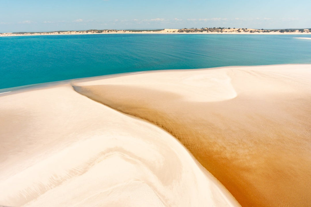 Fresh water and ocean water meet on the sandy dunes taken from aerial perspective in Bazaruto Archipelago, Mozambique