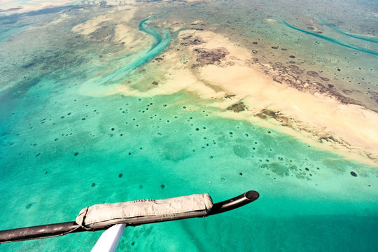 Aerial image taken from helicopter of clear blue water and reefs in Bazaruto Archipelago, Mozambique