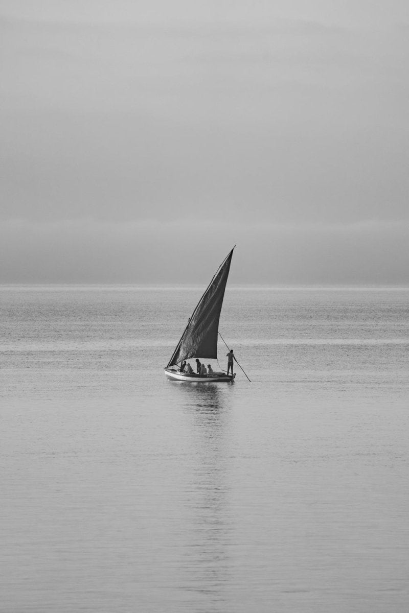 Black and white image of dhow sailors beginning their journey to catch fish in Bazaruto Archipelago, Vilankulos, Mozambique