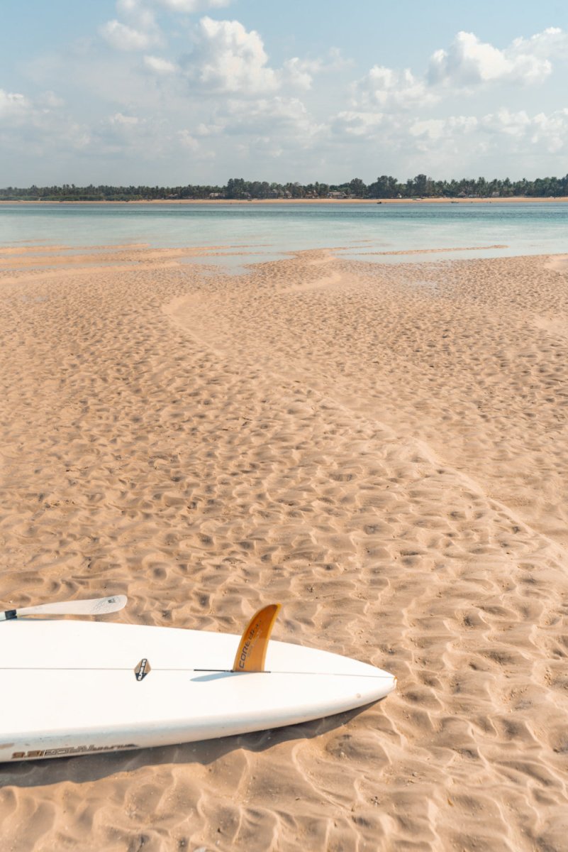 Stand up paddle board lying on a calm beach along tropical waters in Bazaruto Archipelago, Vilankulos, Mozambique