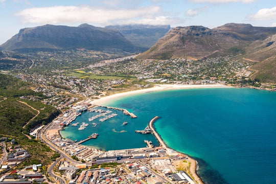 Aerial image of Hout Bay Harbour and its beach in Cape Town, South Africa.