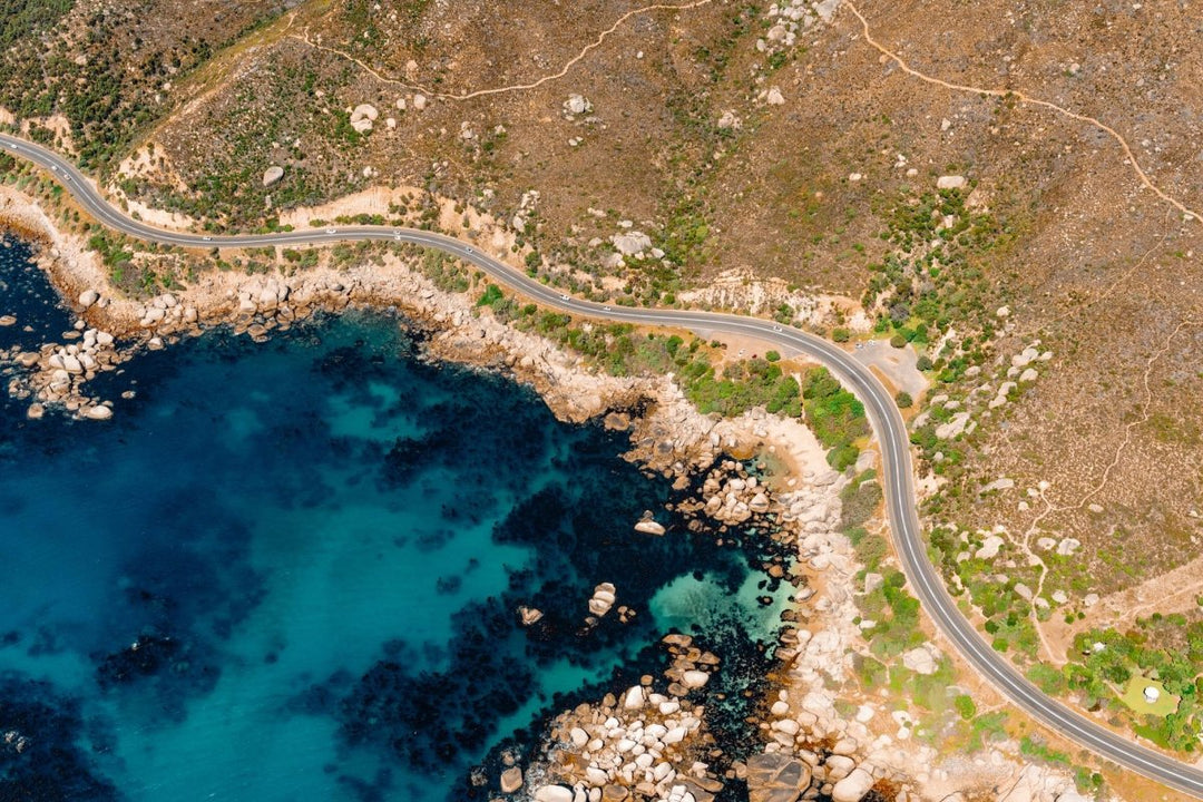 Aerial image of Cosy Bay Beach and Victoria Road in Cape Town, South Africa.