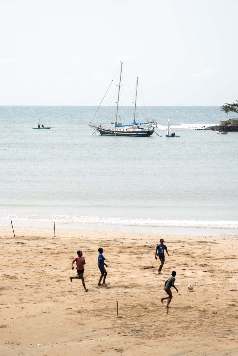 Local kids playing football on the beach along the coast of Sao Tome and Principe.