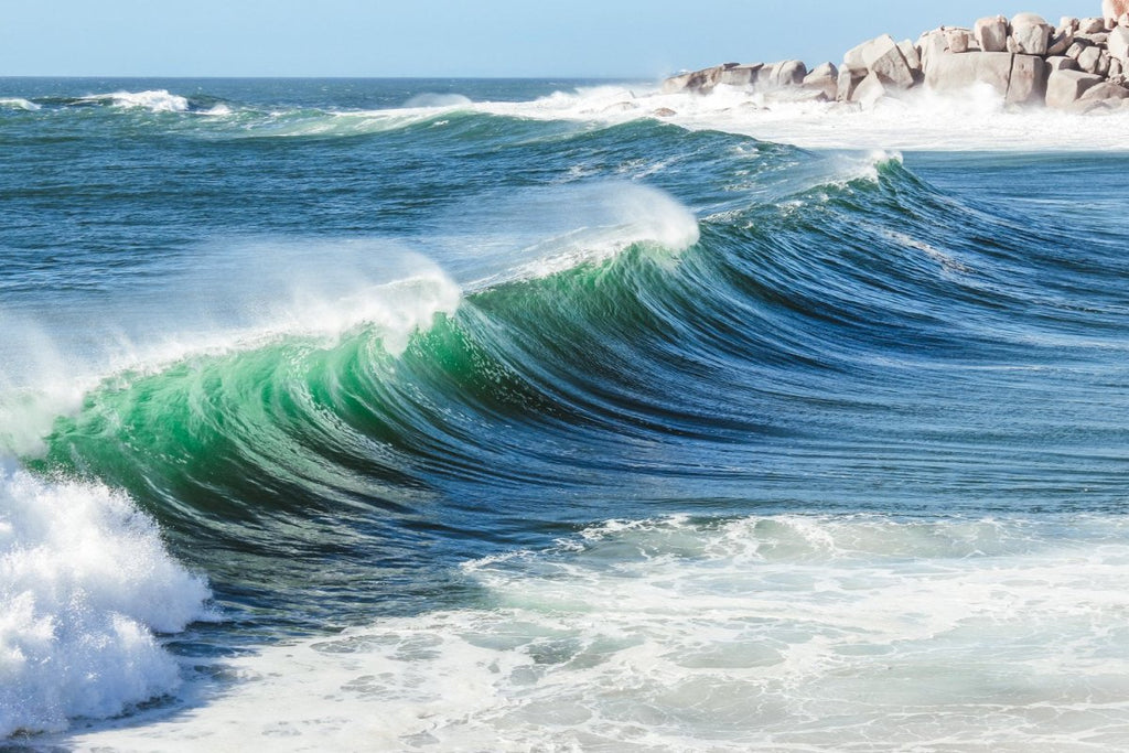 Wave breaking at Llandudno beach in Cape Town