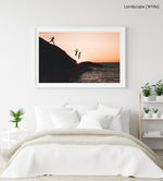 Three guys cliff jumping at sunset into ocean at Llandudno Beach in a white fine art frame