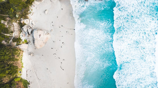 Aerial of Llandudno beach and waves crashing on sand