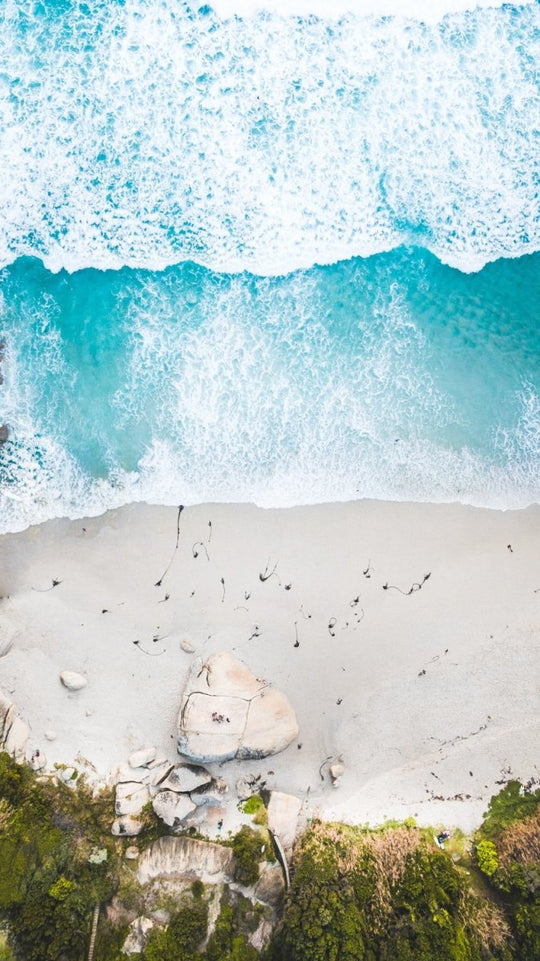 Aerial of Llandudno beach and waves crashing on sand