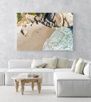 Aerial hightide waves flowing along beach boulders at Llandudno Beach in Cape Town in an acrylic/perspex frame