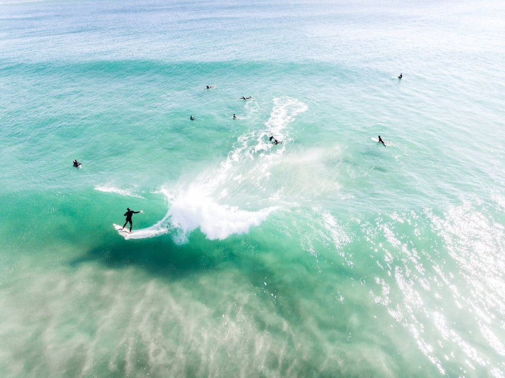Aerial of surfer carving on a green wave taken at Llandudno Beach in Cape Town