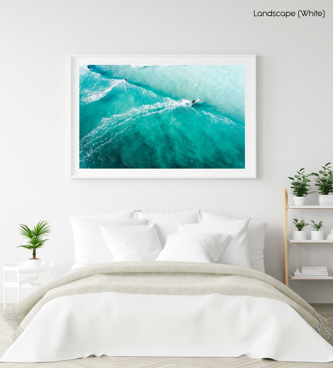 Three people surfing blue wave in Cape Town from above in a white fine art frame
