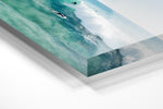 Aerial surfer going right on a small blue wave in an acrylic/perspex frame