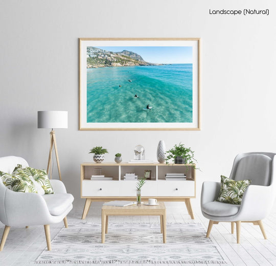 Aerial of surfers waiting on surfboards for a wave at Llandudno Beach in a natural fine art frame