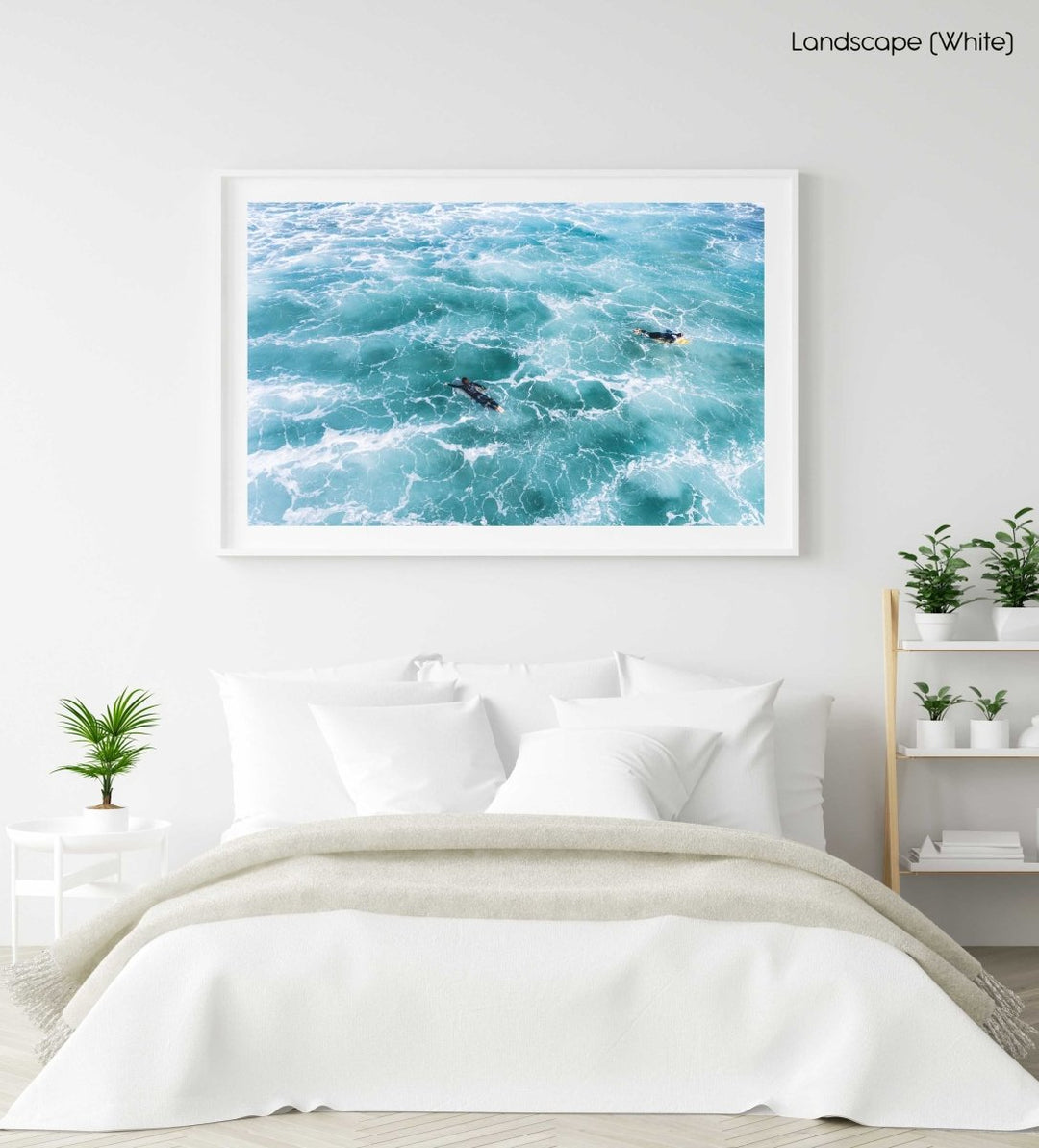 Aerial of two surfers paddling in foamy waves in a white fine art frame