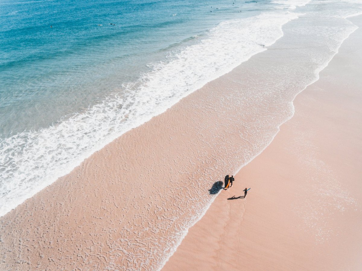 Aerial of father and daughter playing on Cape Town beach