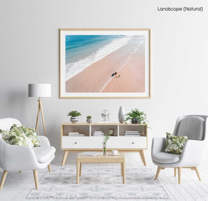 Aerial of father and daughter playing on Cape Town beach in a natural fine art frame
