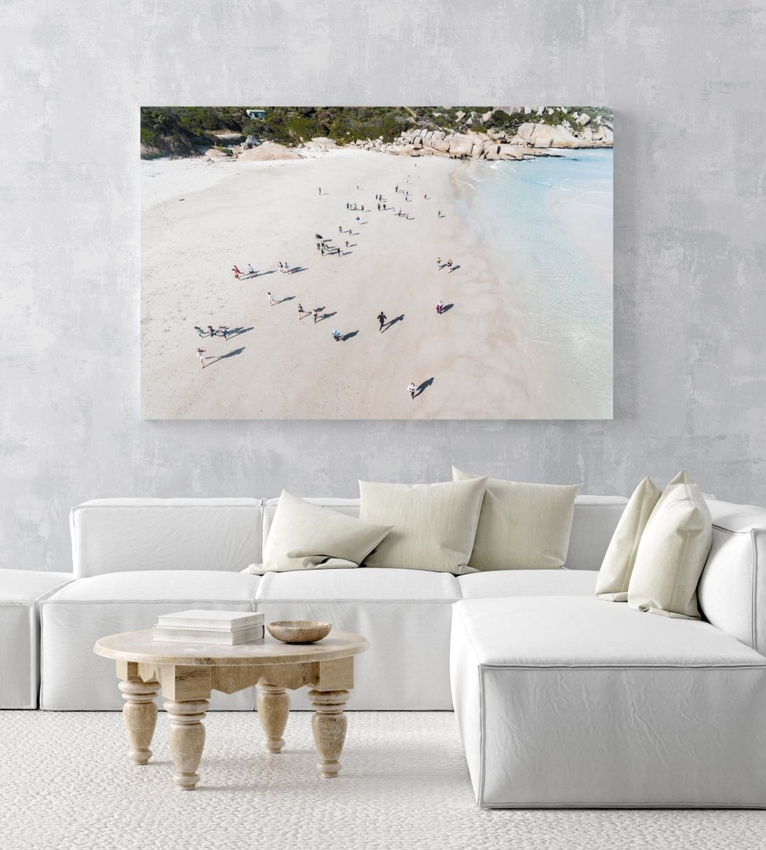 Aerial lifesavers running during training on Llandudno Beach in Cape Town in an acrylic/perspex frame