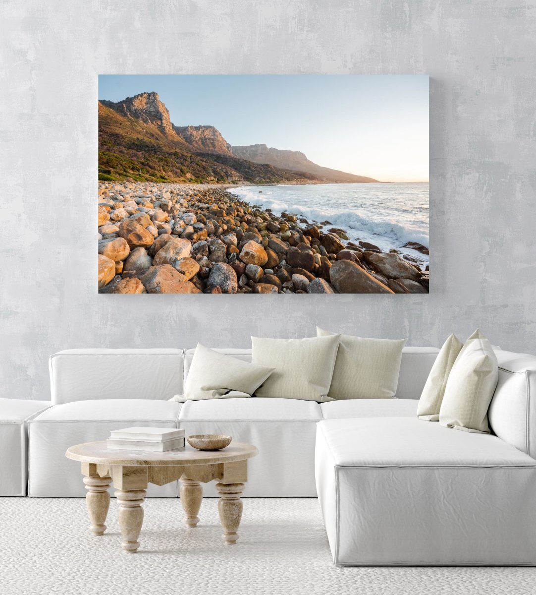 Pebbles and the sea at the twelve apostles mountains in Cape Town in an acrylic/perspex frame