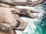 Modern shaped boulders in the ocean in Cape Town aerial