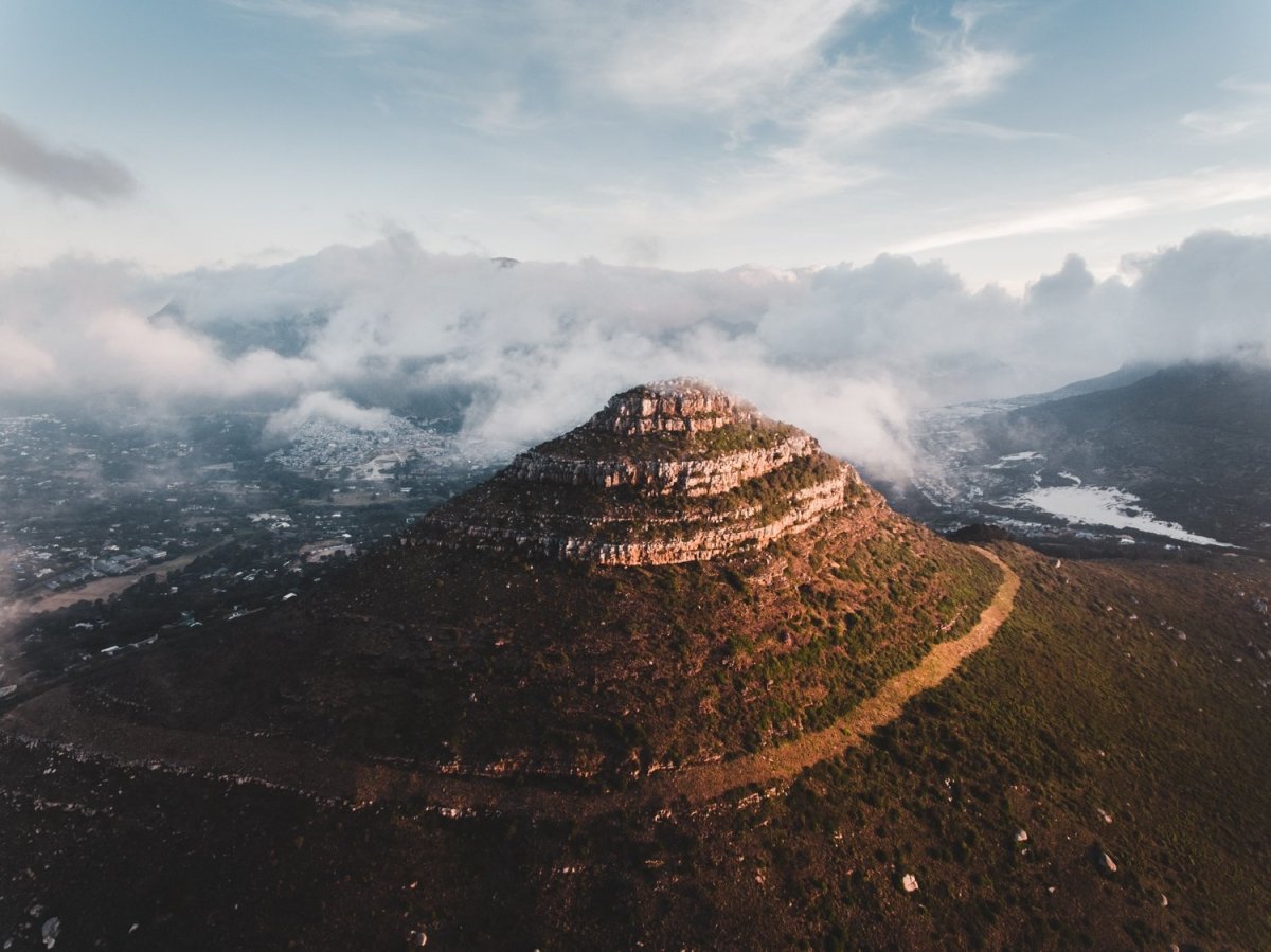 Aerial little lions head in hout bay at sunset in clouds