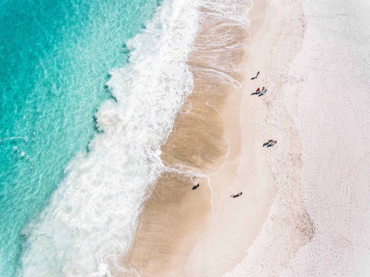 Aerial blue water and people walking on Camps Bay beach Cape Town