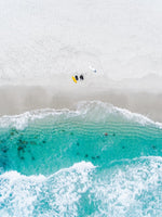 Aerial of two surfers sitting on Glen Beach in Cape Town