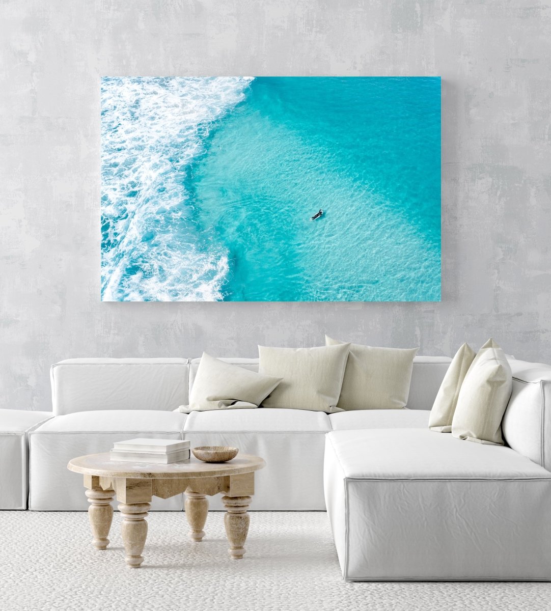 Aerial of surfer paddling in bright blue water in Cape Town in an acrylic/perspex frame