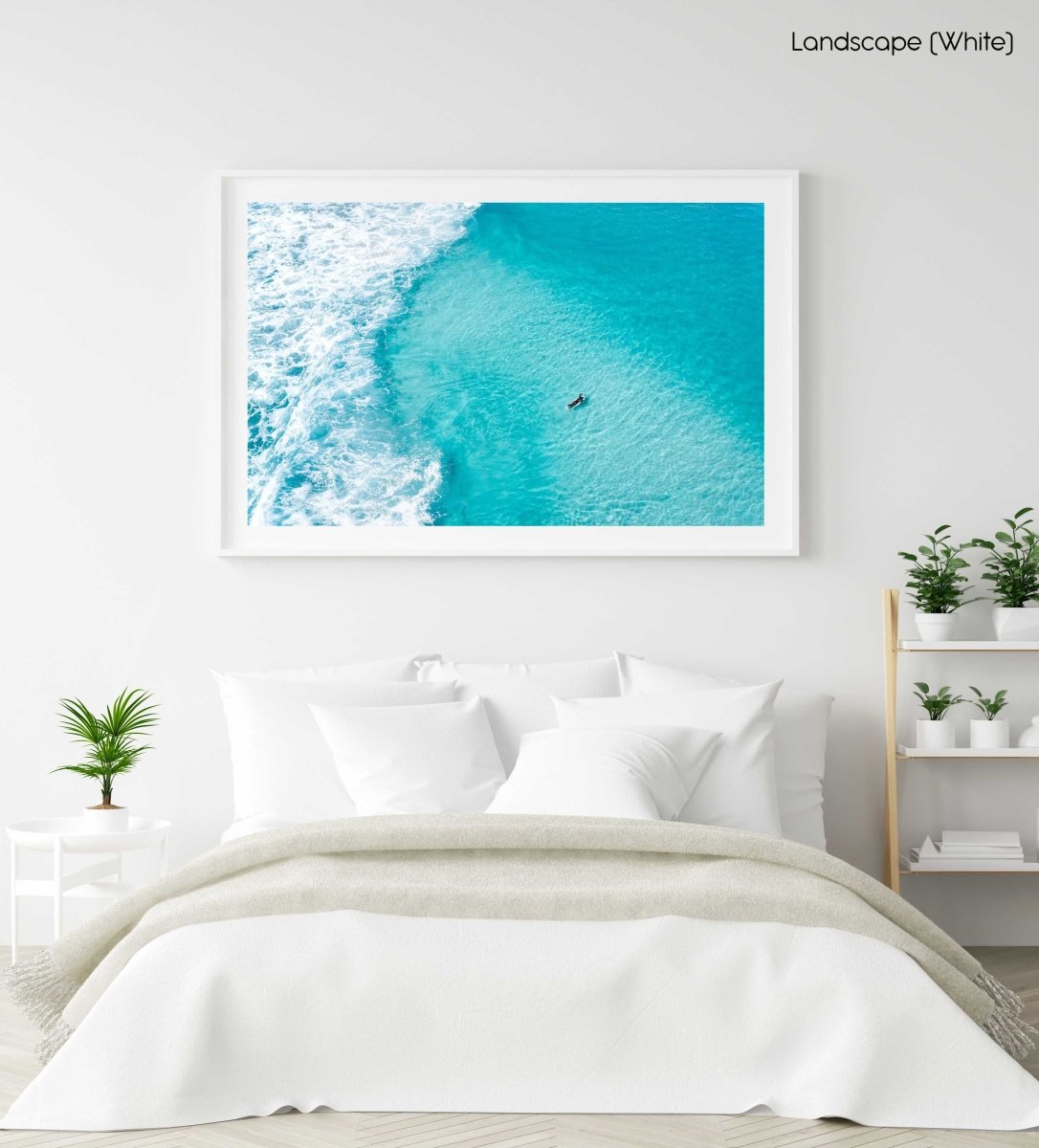 Aerial of surfer paddling in bright blue water in Cape Town in a white fine art frame