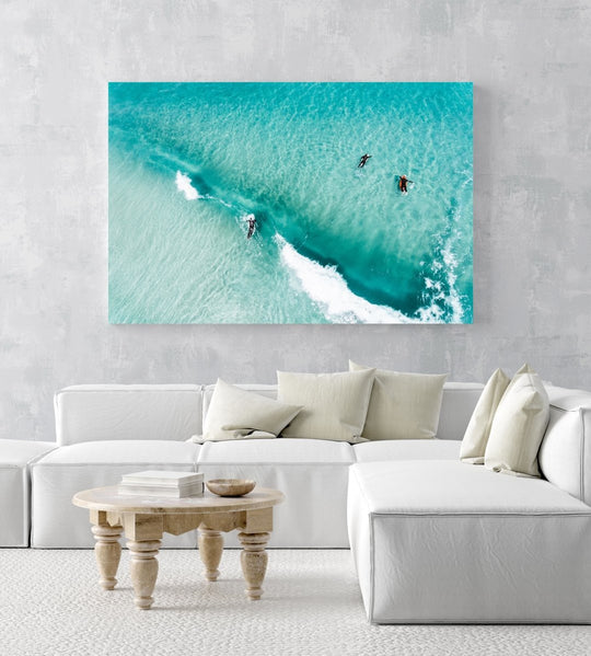 Aerial of surfers duckdiving blue wave at Glen Beach in Cape Town in an acrylic/perspex frame