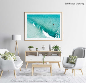 Aerial of surfers duckdiving blue wave at Glen Beach in Cape Town in a natural fine art frame
