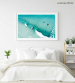 Aerial of surfers duckdiving blue wave at Glen Beach in Cape Town in a white fine art frame