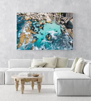 Aerial of blue water and rocks along Camps Bay in Cape Town in an acrylic/perspex frame