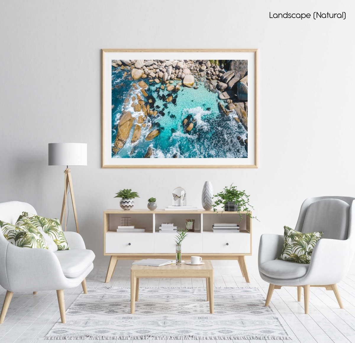 Aerial of blue water and rocks along Camps Bay in Cape Town in a natural fine art frame