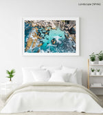 Aerial of blue water and rocks along Camps Bay in Cape Town in a white fine art frame