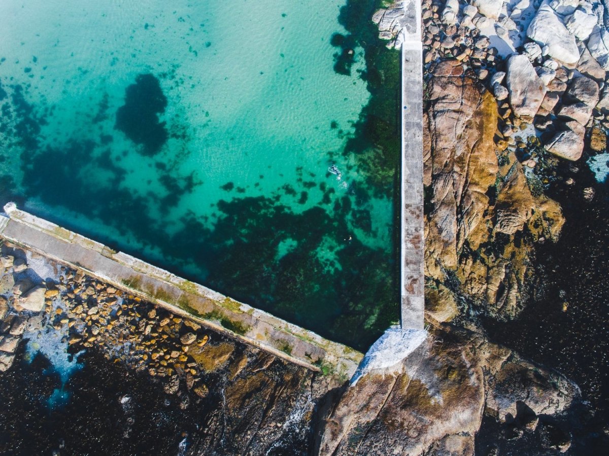 Aerial of camps bay green and blue tidal pool