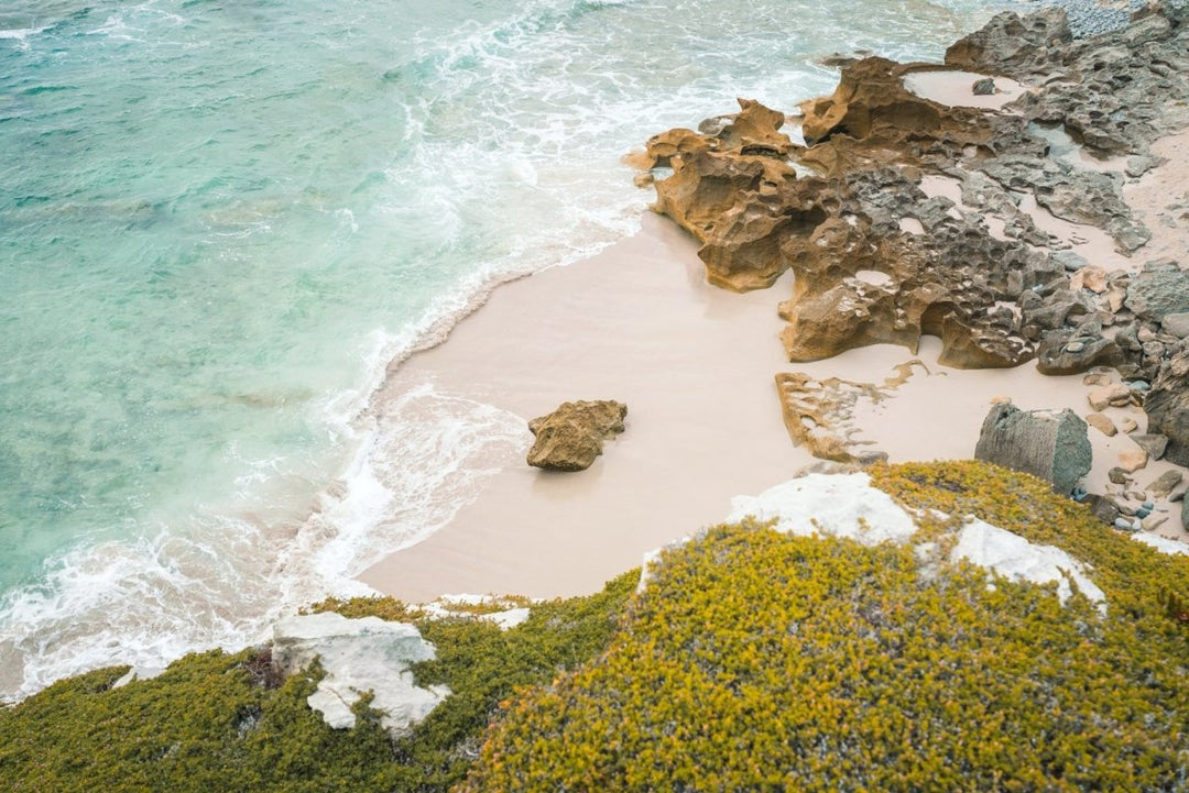 Rock in middle of a sandy beach in arniston south africa