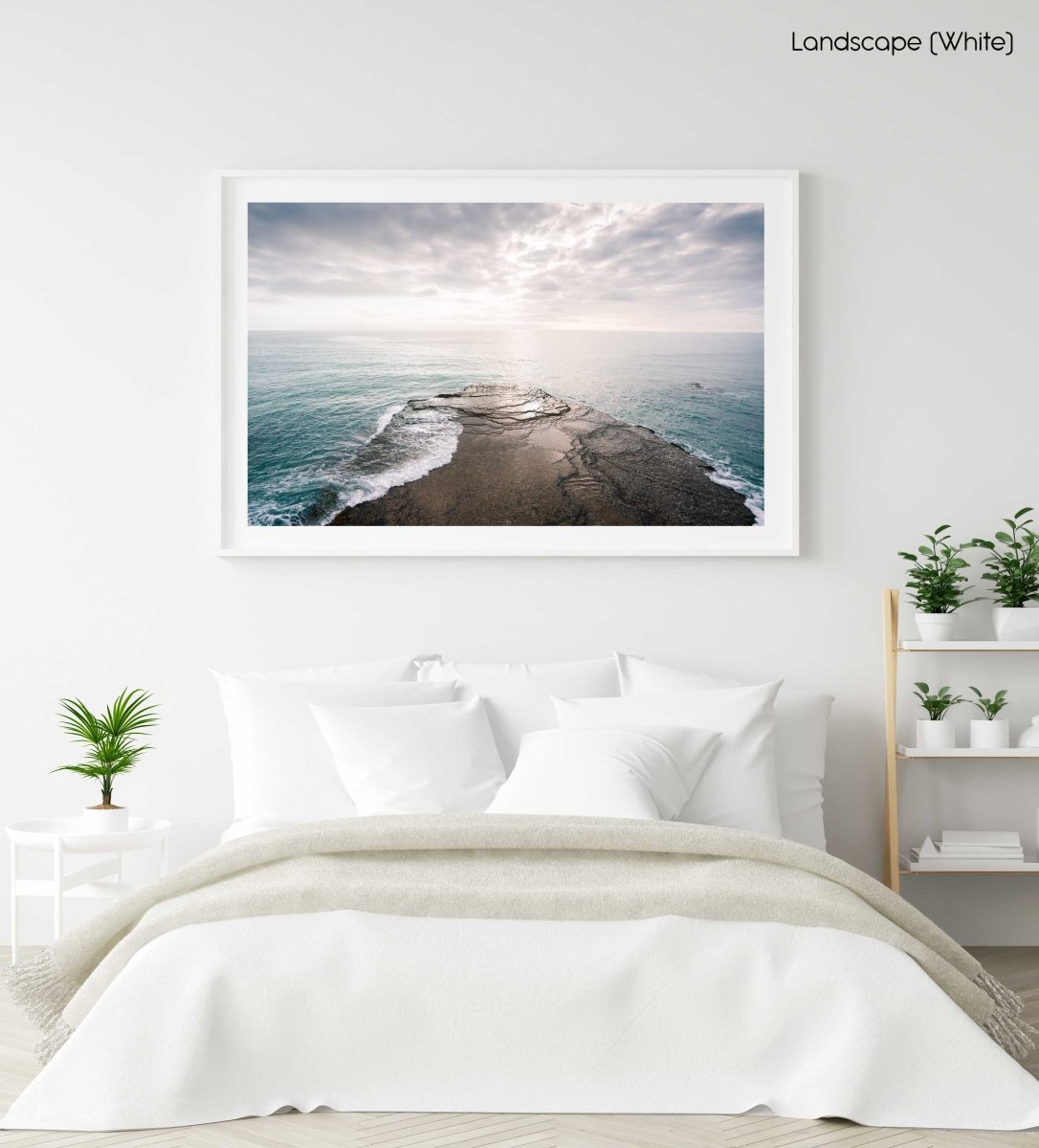 Sunset light on horizon of sea with rock in arniston in a white fine art frame